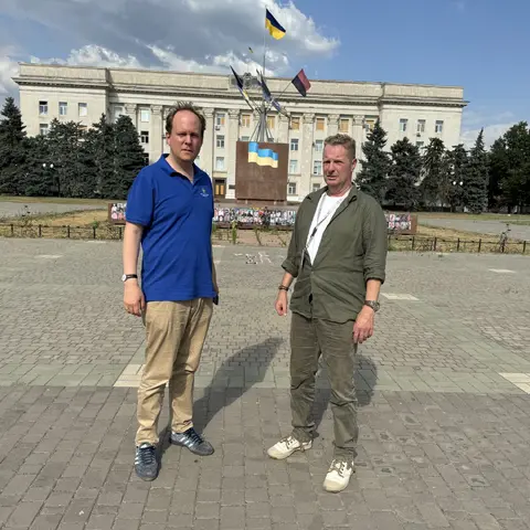 On Freedom Square in Kherson, pictures of deceased soldiers on the pedestal